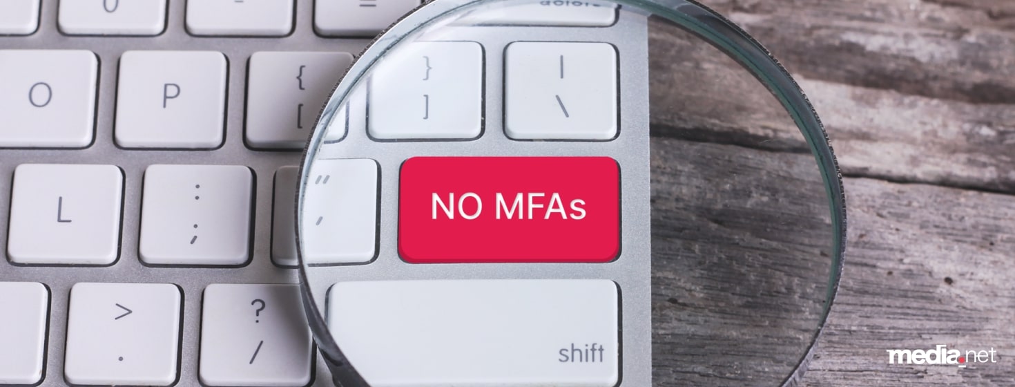 Media.net visual emphasizing its stance against Made for Advertising (MFA) sites, featuring a red 'NO MFAs' key on a keyboard under a magnifying glass